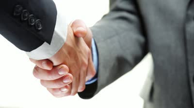 stock-footage-business-handshake-two-businessman-shaking-hands-closeup-motion-track-high-definition